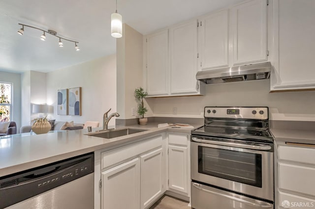 2225 23rd St Unit 318, San Francisco, CA 94107 - kitchen featuring under cabinet range hood, stainless steel appliances, white cabinetry, and open floor plan