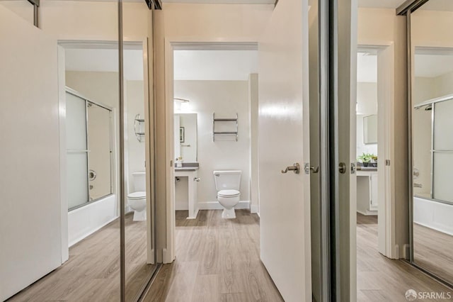 2225 23rd St Unit 318, San Francisco, CA 94107 - bathroom with wood finished floors and combined bath / shower with glass door