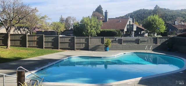 view of pool with a fenced in pool, a patio, and fence