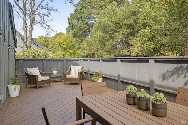 wooden terrace featuring outdoor dining area and an outdoor hangout area