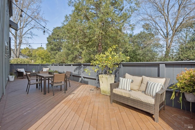 wooden deck featuring outdoor dining space and an outdoor living space