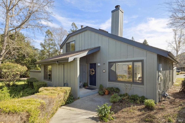 view of front of house featuring board and batten siding and a chimney