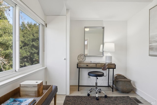 office featuring visible vents, baseboards, and wood finished floors