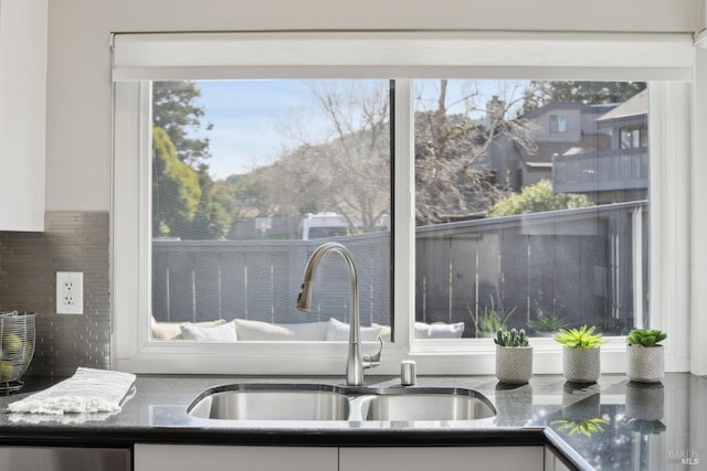 details featuring dishwasher, white cabinetry, and a sink