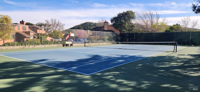 view of sport court with fence