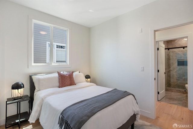 bedroom with light wood-style flooring and baseboards