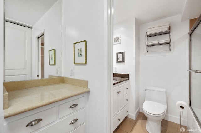 bathroom with tile patterned flooring, vanity, and toilet