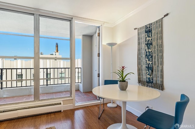 dining space featuring hardwood / wood-style floors, a baseboard radiator, and ornamental molding