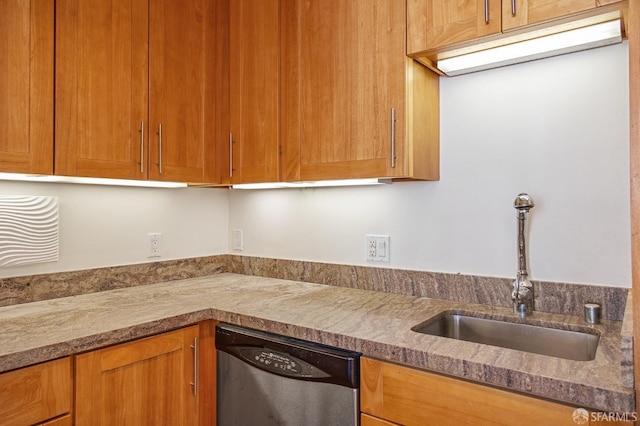 kitchen with light stone counters, stainless steel dishwasher, and sink