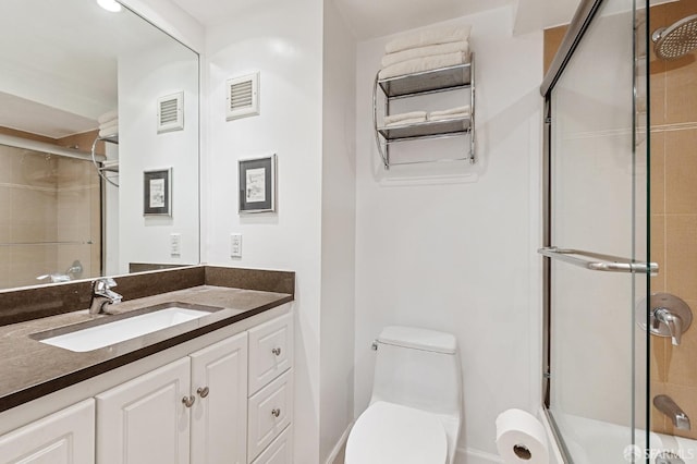 bathroom with vanity, toilet, and walk in shower