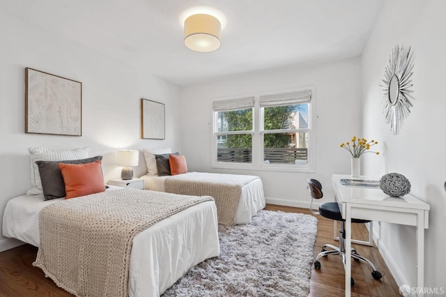 bedroom with dark hardwood / wood-style floors