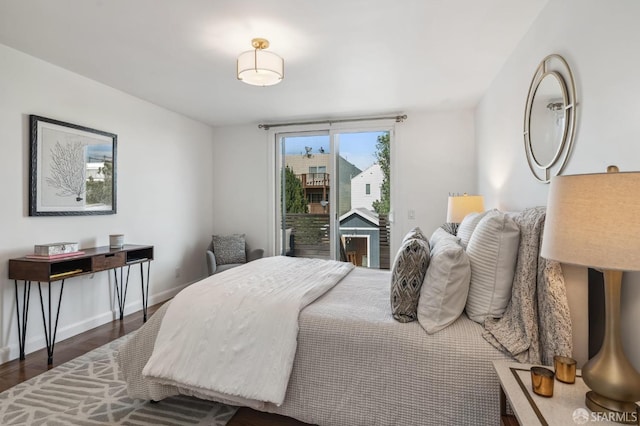 bedroom featuring access to exterior and dark hardwood / wood-style flooring