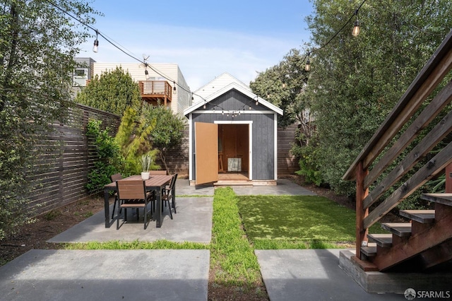 exterior space with a patio area and a storage shed