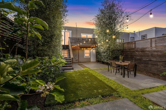 yard at dusk with a patio area