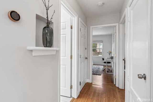 hall with light hardwood / wood-style flooring