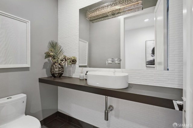 bathroom featuring vanity, tile patterned floors, and toilet