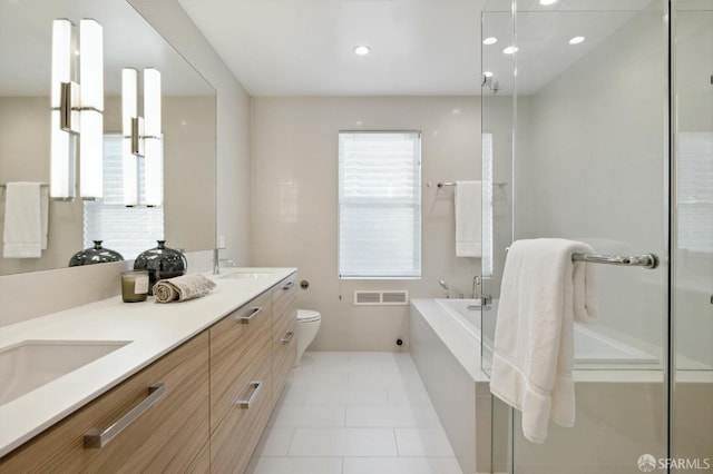 full bathroom featuring plus walk in shower, tile patterned floors, vanity, and toilet