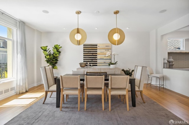 dining area with plenty of natural light and hardwood / wood-style floors