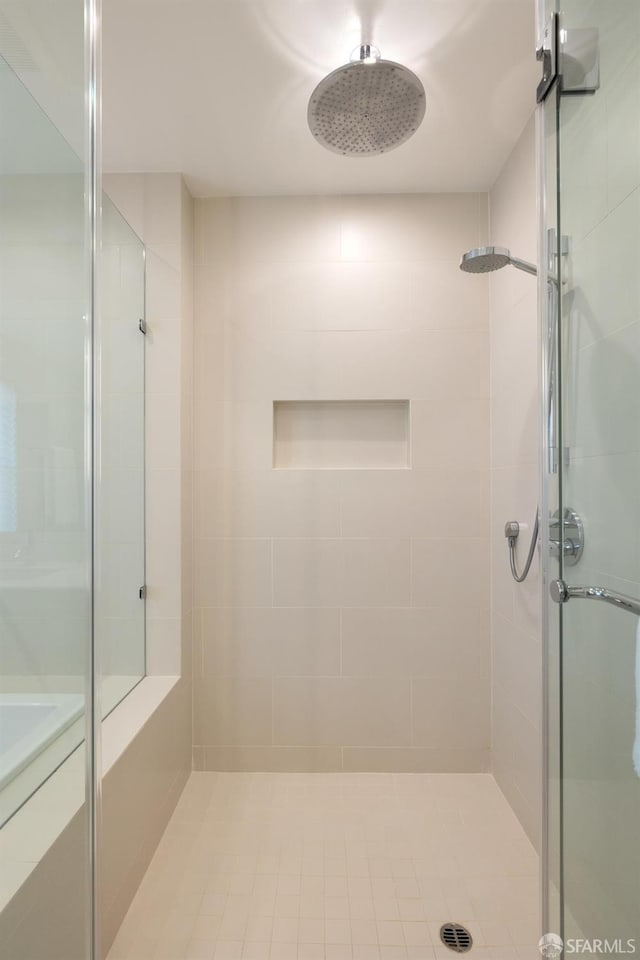 bathroom featuring a shower with shower door