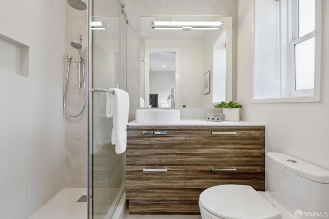 bathroom with walk in shower, vanity, and toilet