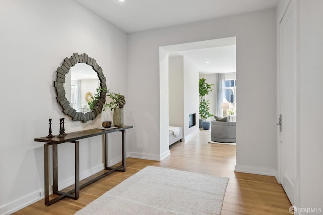 hallway with light hardwood / wood-style flooring