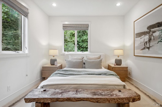 bedroom featuring baseboards, multiple windows, and recessed lighting