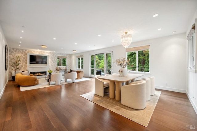 dining room with recessed lighting, baseboards, wood finished floors, and a fireplace