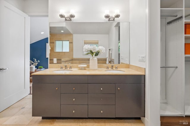 bathroom featuring a sink and double vanity