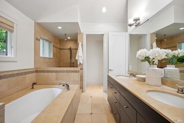 full bath featuring a garden tub, tile patterned flooring, double vanity, tiled shower, and a sink