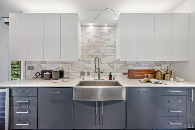 kitchen with gray cabinetry, decorative backsplash, modern cabinets, and wine cooler