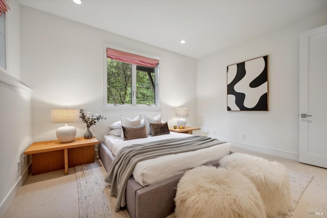 bedroom featuring baseboards, recessed lighting, and light colored carpet