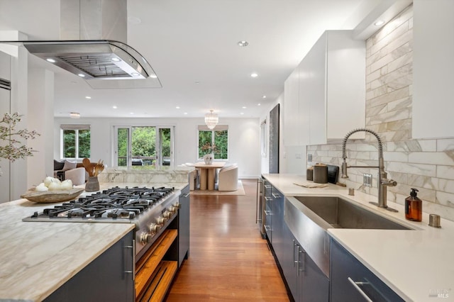 kitchen featuring a sink, modern cabinets, white cabinets, and tasteful backsplash