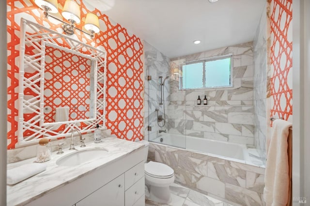 full bathroom featuring vanity, tiled shower / bath, toilet, marble finish floor, and recessed lighting