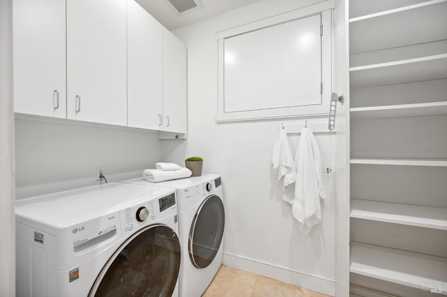 clothes washing area featuring visible vents, cabinet space, light tile patterned floors, baseboards, and washer and dryer