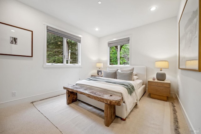 bedroom with recessed lighting, baseboards, and light colored carpet