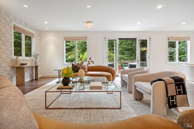 living area with a healthy amount of sunlight, recessed lighting, and wood finished floors