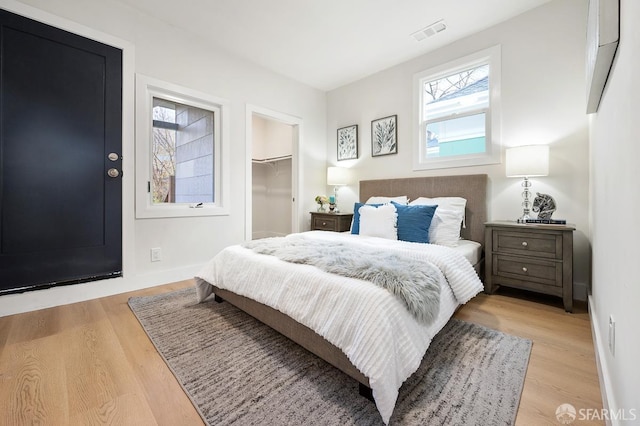 830 47th St, Emeryville, CA 94608 - bedroom featuring light wood finished floors, a spacious closet, baseboards, and a closet