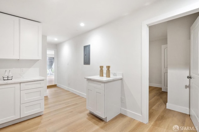 830 47th St, Emeryville, CA 94608 - kitchen featuring electric panel, light wood-type flooring, white cabinets, baseboards, and recessed lighting