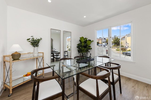 dining area with baseboards, recessed lighting, and light wood-style floors