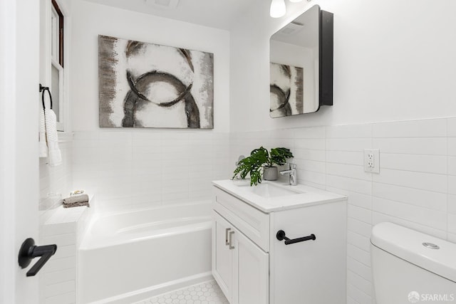 bathroom with a tub to relax in, tile walls, toilet, and vanity