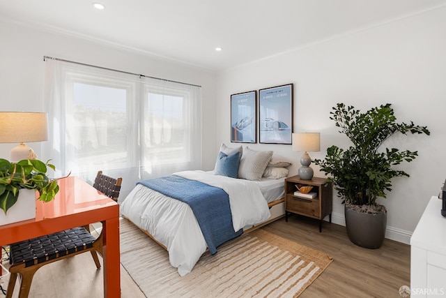 bedroom with recessed lighting, baseboards, and light wood-type flooring