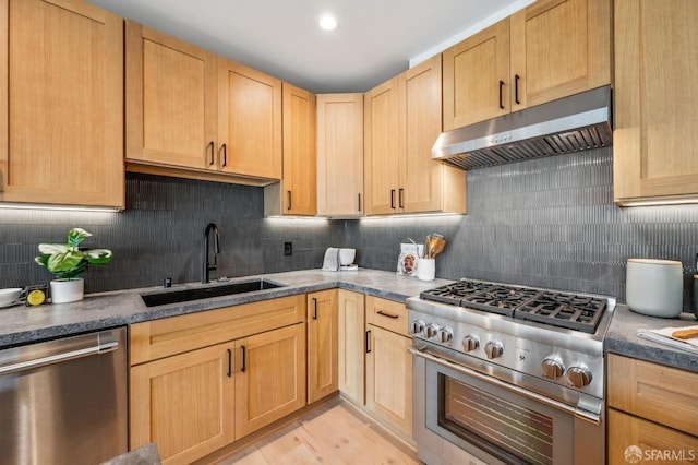 kitchen featuring light brown cabinetry, a sink, appliances with stainless steel finishes, under cabinet range hood, and backsplash