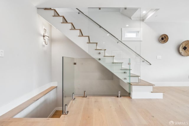 stairs with baseboards and wood finished floors