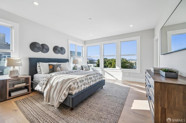 bedroom featuring recessed lighting, wood finished floors, and baseboards