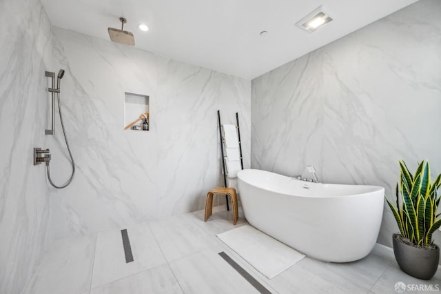 full bath with a marble finish shower and a freestanding bath