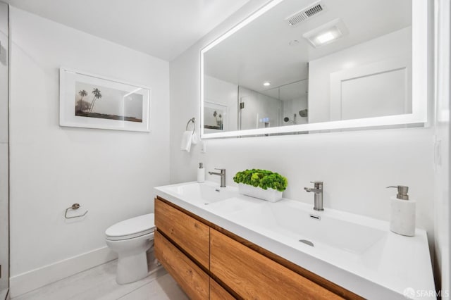 full bathroom featuring visible vents, toilet, walk in shower, and a sink