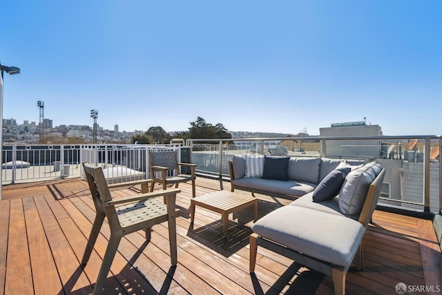 wooden terrace with an outdoor living space