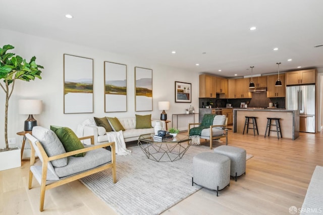 living room with recessed lighting and light wood finished floors