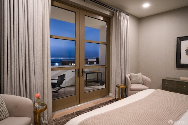 bedroom featuring wood finished floors and french doors