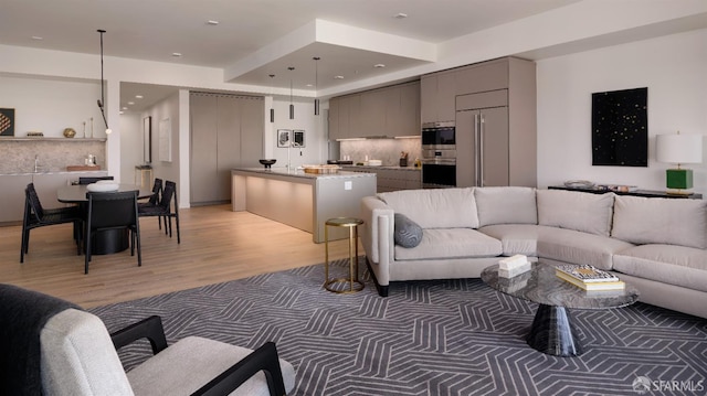 living area featuring light wood-style flooring and recessed lighting